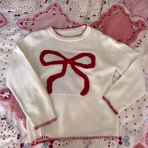 Elegant Cream Sweater with Red Bow Accent